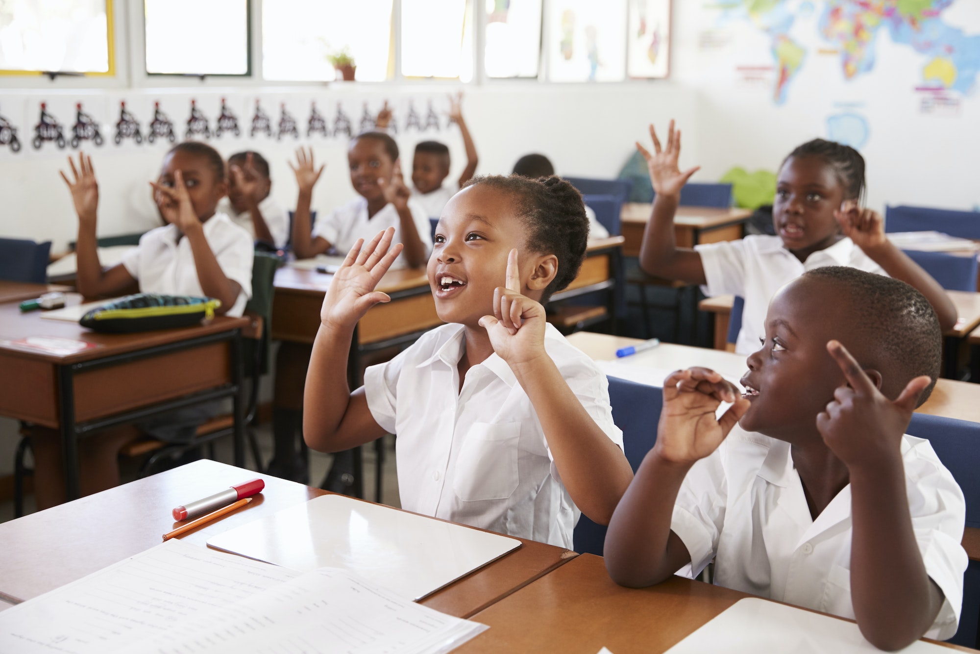 kids-showing-hands-during-a-lesson-at-an-elementary-school.jpg